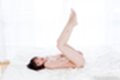 Yurikawa sara lying on her back legs raised bare feet